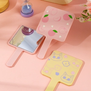 Cat and peach motif handheld makeup mirrors in pink and yellow with ergonomic handles