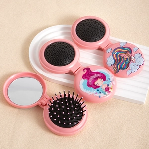 Pink foldable mermaid travel hairbrush with built-in mirror and cartoon illustration