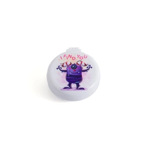 Close-up of portable white folding hairbrush with purple cartoon monster and mirror