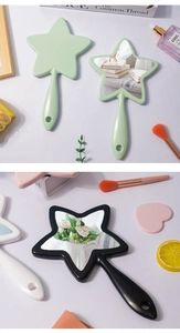 Detailed view of star-shaped handheld makeup mirrors with handle and hanging hole