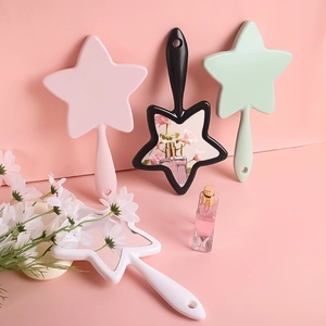 Star shaped handheld mirrors in pink, black, green, and white colors for daily makeup use