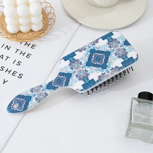 Bohemian mandala pattern air cushion paddle brush with scalp massage bristles on desk