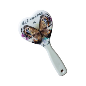 White heart-shaped massage hairbrush with artistic butterfly print and hanging hole