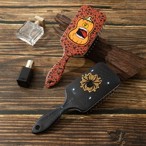 Halloween pumpkin and spider embroidery air cushion hairbrushes on wood background