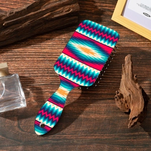 Detail of bohemian wavy pattern on colorful air cushion hairbrush over rustic wood