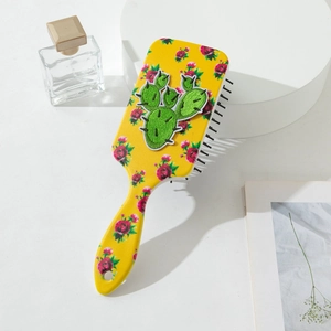 Brosse à cheveux de massage florale avec patch cactus sur manche ergonomique jaune vif