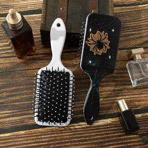 Halloween paddle hairbrush set with spider and web print on dark wood background