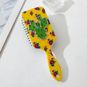 Brosse à cheveux jaune avec motif de roses et écusson cactus sur fond blanc