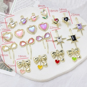 Macro shot of assorted alloy charms for DIY jewelry including stars and tulips
