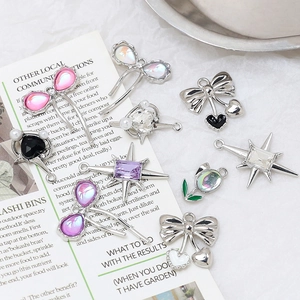 Assorted DIY jewelry charms featuring stars bows tulips and hearts with shiny metal finish