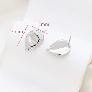 Detailed macro view of 19mm silver irregular oval earring charms for DIY jewelry making