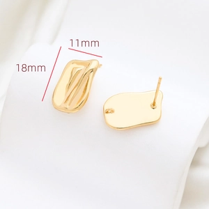 Detailed view of irregular wavy gold earring studs with DIY loops for jewelry making