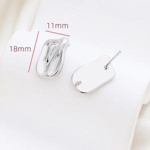 Detailed silver irregular rectangular earrings with lava texture and hanging loops