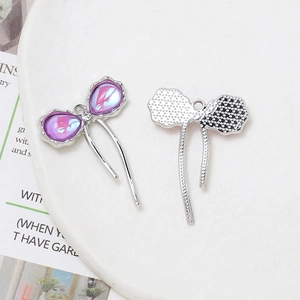 Detailed macro view of purple bow charm with silver textured back and ring for DIY jewelry