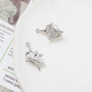 Detail of silver star pendants with zircon and pearl for DIY jewelry making