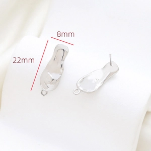 Detail of 22mm irregular lava textured metal stud earrings with small DIY hanging loops