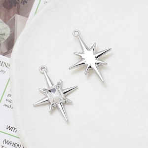 Detail of silver alloy star charms with zircon inlay for DIY jewelry making