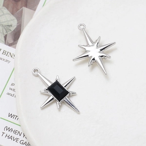 Macro shot of starburst pendants with black gems for DIY necklaces and earrings