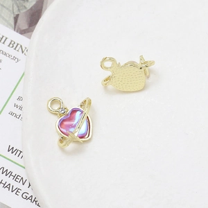 Macro detail of heart-shaped planet pendant with purple gradient and gold texture