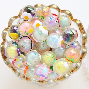 Macro detail of colorful hand-painted glass beads with AB coating in a glass bowl