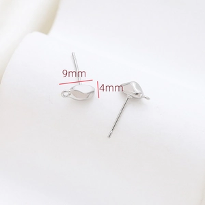 Macro detail of 9x4mm silver-plated earring studs with small loops for jewelry making