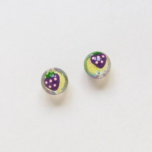 Detail of handmade glass strawberry beads with yellow foil and cracked texture