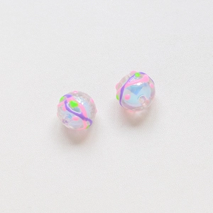 Macro shot of hand-painted tulip-style beads with colorful dots for DIY jewelry making