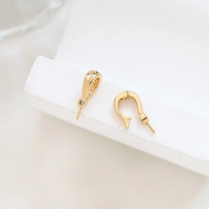 Macro shot of gold plated pearl bail with zircon stone and peg for DIY jewelry