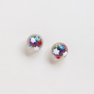 Detailed view of spherical resin beads with colorful glitter and red star accents