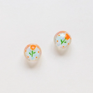 Detail of iris-finish glass beads with hand-painted orange tulips for DIY jewelry