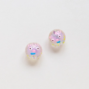 Detailed view of handmade cartoon face glass beads with purple core and colorful hand-painted art
