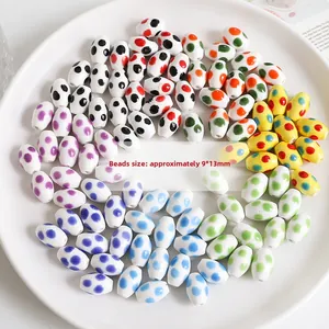 Macro view of 9x13mm oval ceramic beads with colorful polka dots for DIY jewelry