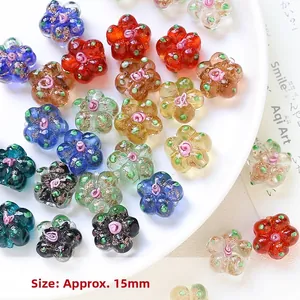 Macro detail of 15mm colorful glass flower beads with hand-painted pink relief centers