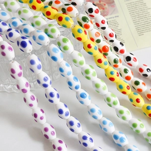 Handmade ceramic oval beads with colorful polka dots for DIY jewelry making and crafts
