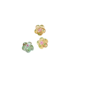 Hand-painted glass flower beads in amber and mint green for DIY jewelry making