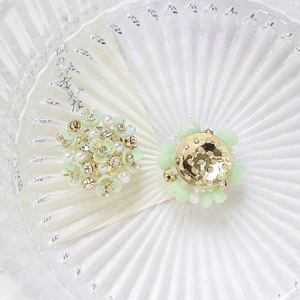 Macro view of handmade floral craft accessories with mint flowers, pearls and crystals