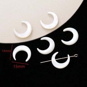 Macro shot of 14x15mm crescent moon white mother of pearl shell beads for jewelry making