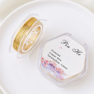 Detailed macro view of 0.6mm gold-plated copper wire for DIY jewelry making and beading