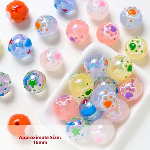 Macro shot of 16mm colorful acrylic beads with cat paw and star patterns for DIY jewelry