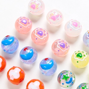 Close-up of colorful acrylic beads with cat paw and moon patterns for DIY jewelry making