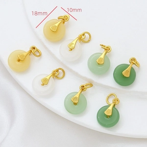 Detailed view of 18mm imitation jade donut pendants with decorative gold plated bails