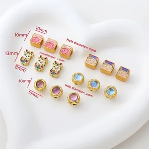 Detail of 18K gold plated rabbit and lucky cat enamel beads for DIY jewelry making