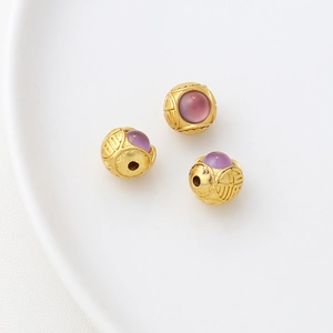 Macro shot of 18k gold-plated lucky rabbit beads with purple stone and Fu character