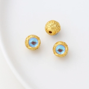 Detailed view of three gold rabbit charms with blue enamel inlay for DIY jewelry making