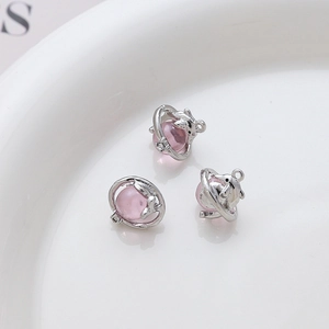 Macro shot of dolphin alloy pendant with pink translucent resin orb for DIY jewelry