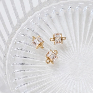 Close-up of gold-plated heart and star charms with sparkling cubic zirconia crystals