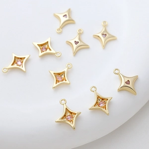 Detailed view of 14k gold plated star charms with pink zircon inlay for DIY jewelry making