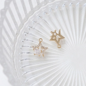 Detail of gold star pendant with micro-pave cubic zirconia and central star-cut stone