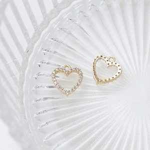 Close-up of gold-plated heart charms with micro-paved cubic zirconia for DIY jewelry