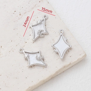 Macro view of 24mm silver alloy star and moon pendant with mother of pearl inlay